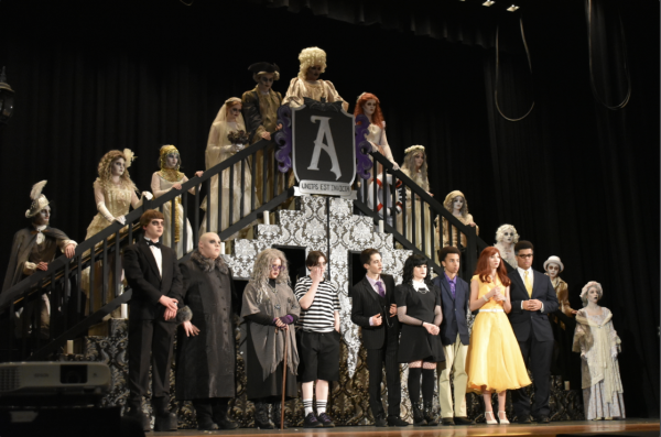 The cast of The Addams Family performs one of their numbers on stage. 